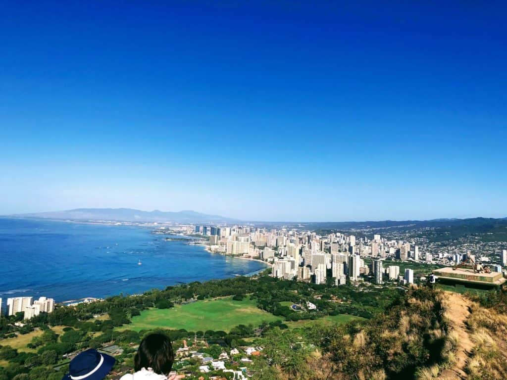 Panoramic views of Waikiki skyscrapers and ocean from the top of Diamond Head crater. Diamond Head hike is one of the top Waikiki activities.
