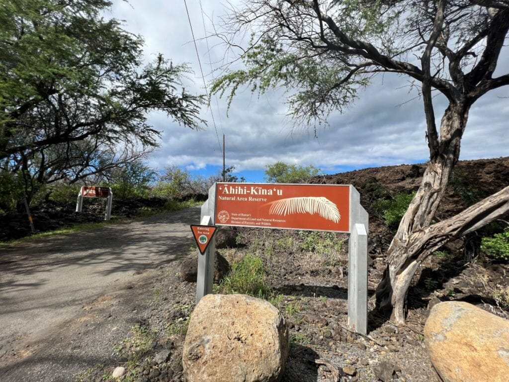 A sign next to a unpaved road that reads Ahihi-Kinau Natural Area Reserve