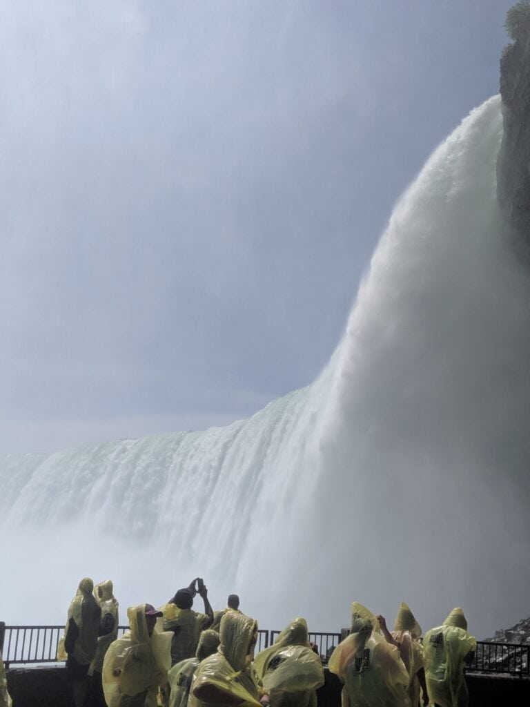 People watching the Niagara Falls up close from a deck
