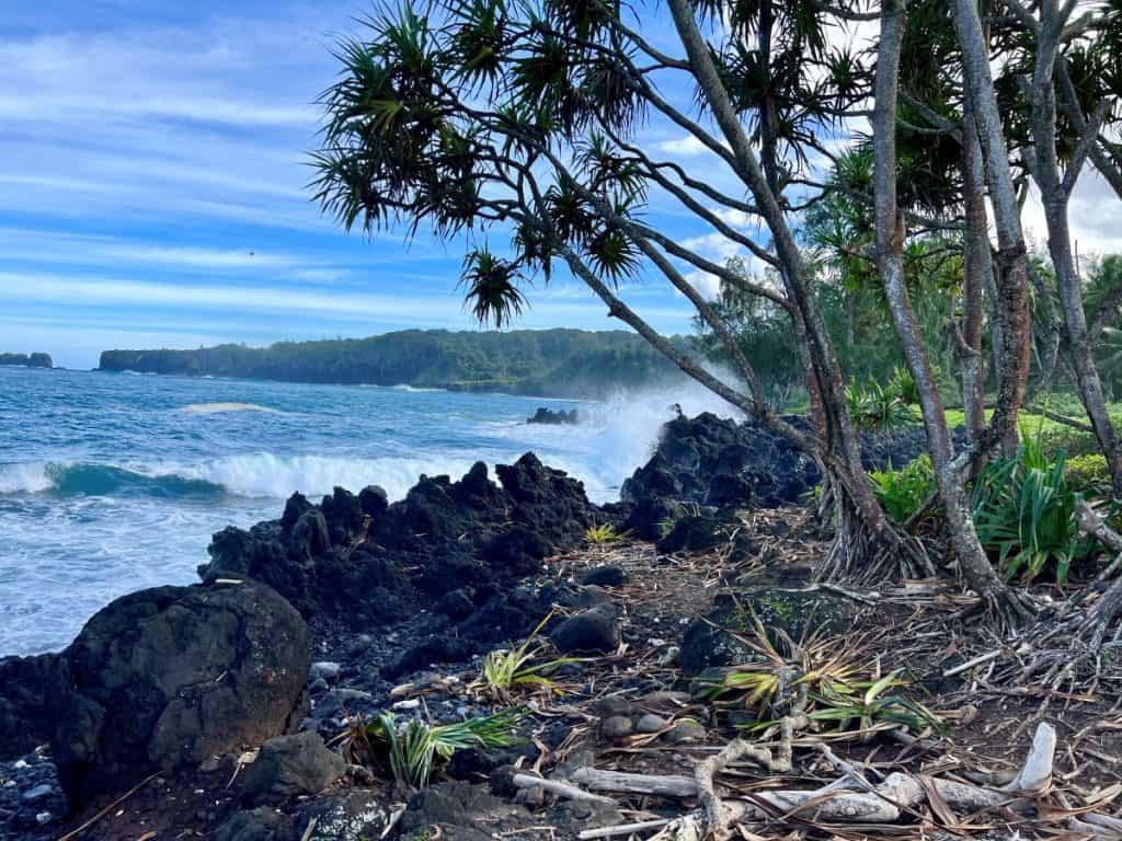 Ocean waves crashing against lava rocks at Kaenae Peninsula 