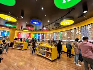 Colorful wall full of M&M dispensers at M&M World Las Vegas - Visiting here is the best things to do in Las Vegas with kids
