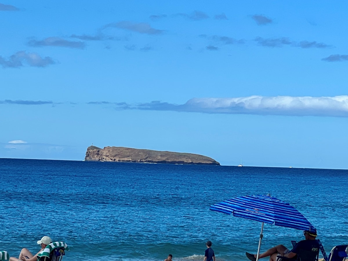 the back wall of the crescent shaped Molokini crater seen from the beach