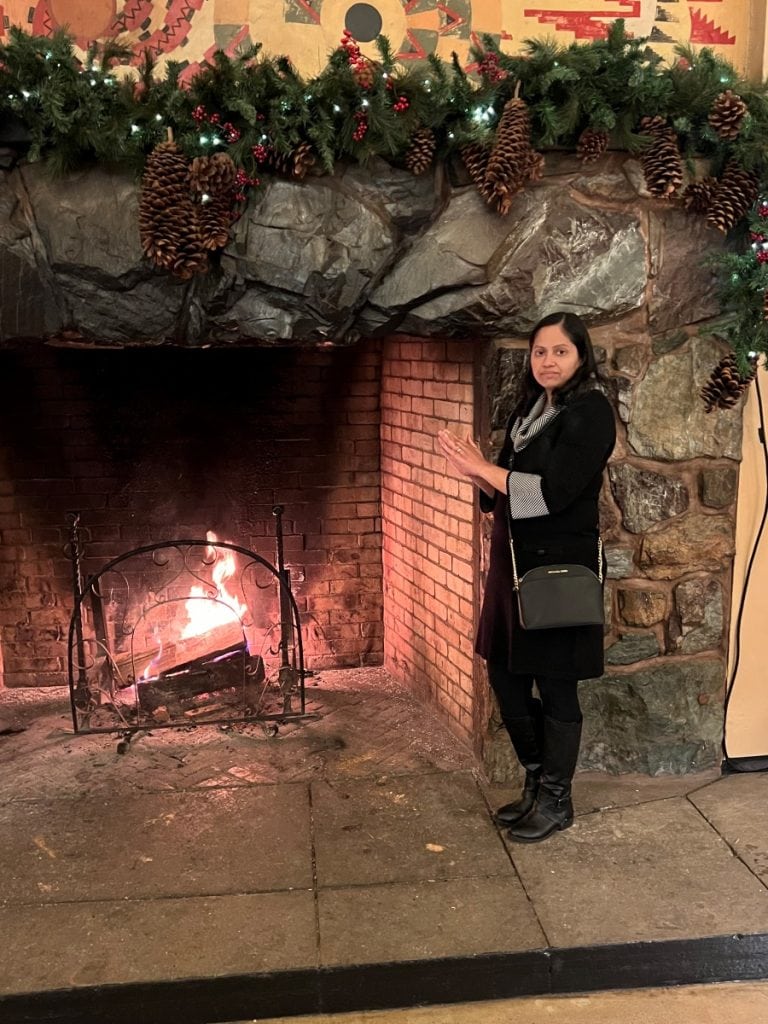 Girl standing near a huge fireplace at the Ahwahnee Hotel in Yosemite