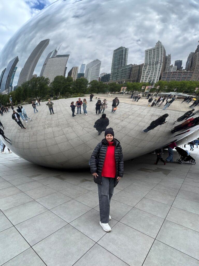 a girl posing in front of the Bean Chicago
