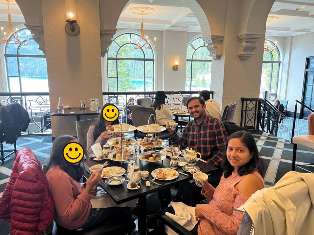 A family seated enjoying afternoon tea at Fairmont Lake Louise Hotel