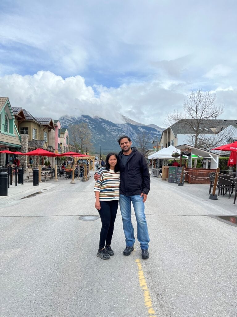 A couple posing on a street in a mountain town
