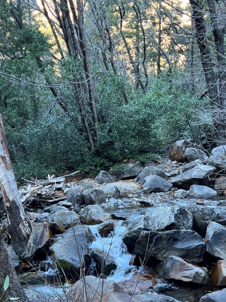 Creek flowing on a rocky river bed next to Bridalveil fall 