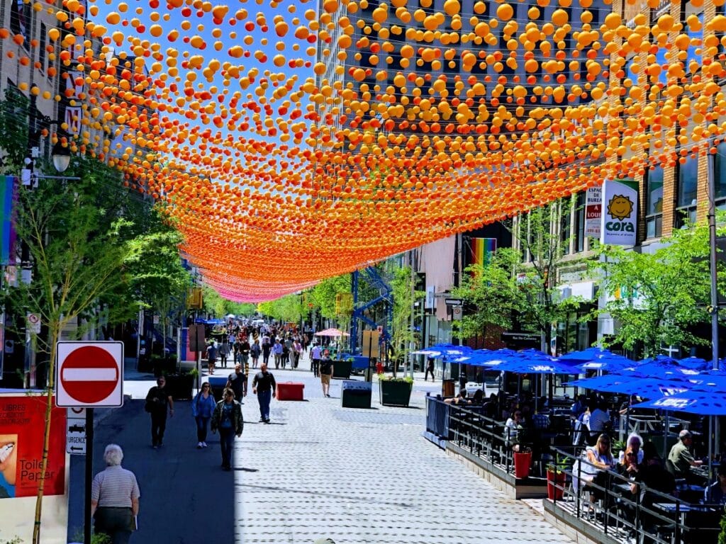 A beautiful street in Montreal decorated with orange garlands