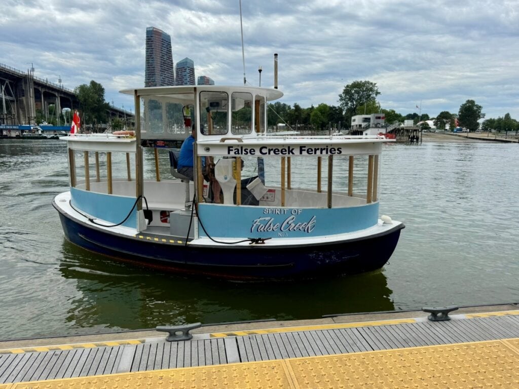 A small blue False Creek Ferry boat