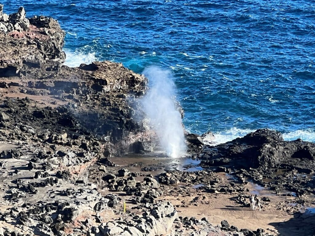 a blowhole near the ocean with water spouting out