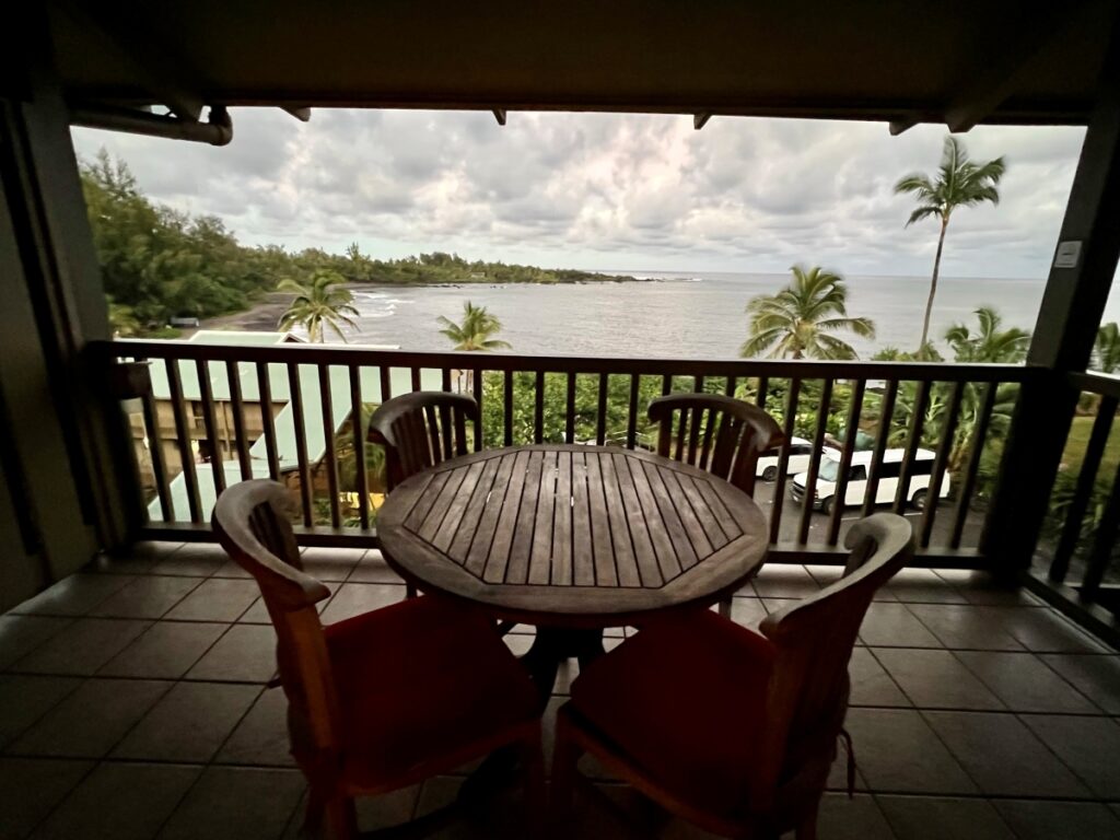 A balcony with a patio set and ocean views